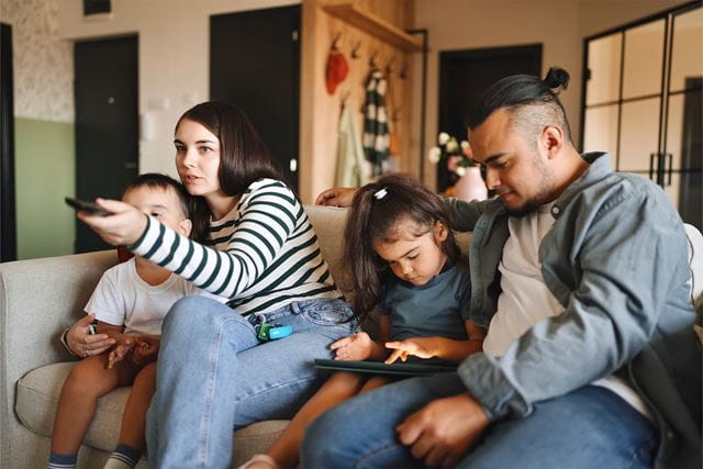 Family in living room watching TV