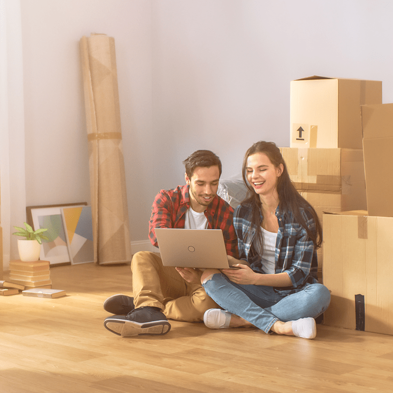 Broadband on page banner couple moving with boxes and laptop