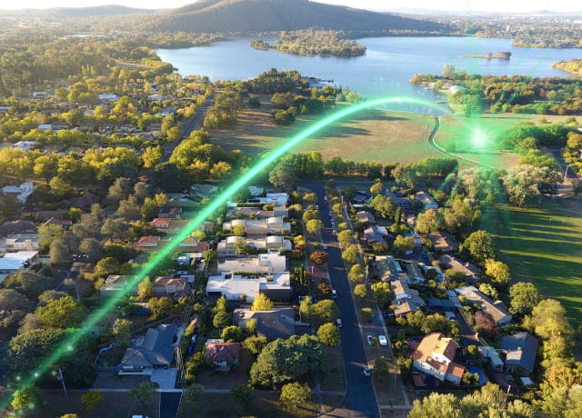 Lakeside residential area with a green light streak