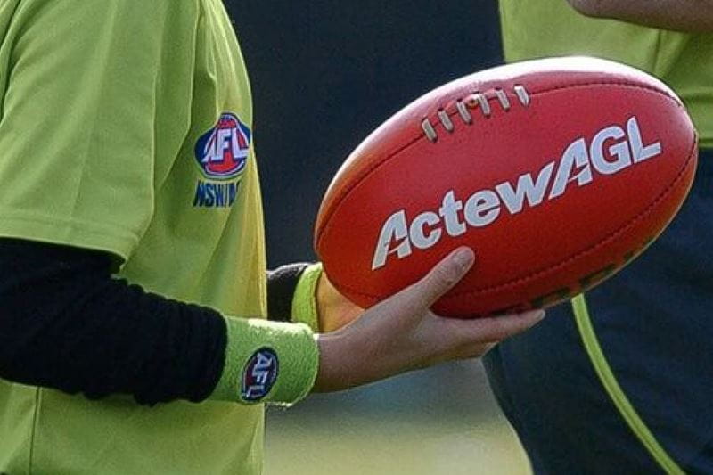 Sportsperson holding an ActewAGL football