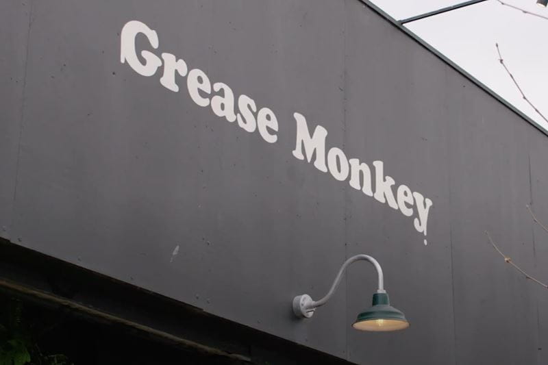 Grease Monkey logo displayed on the side of a building