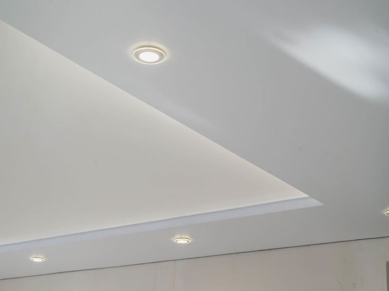 A bright white ceiling featuring overhead lighting elements.