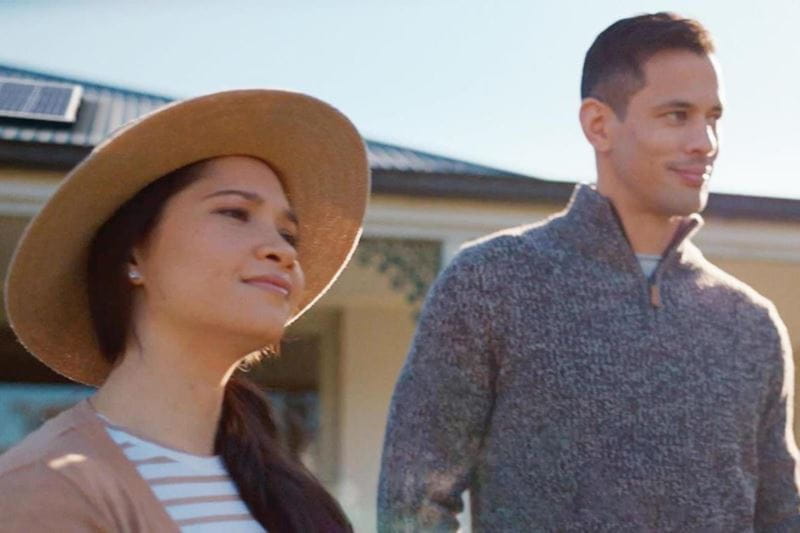 a woman and a man standing and smiling