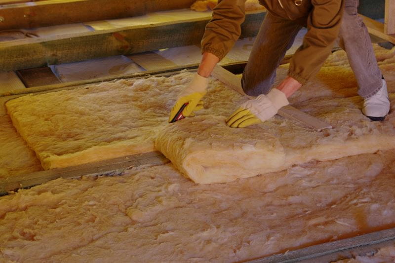 Worker working on insulation upgrade on the roof