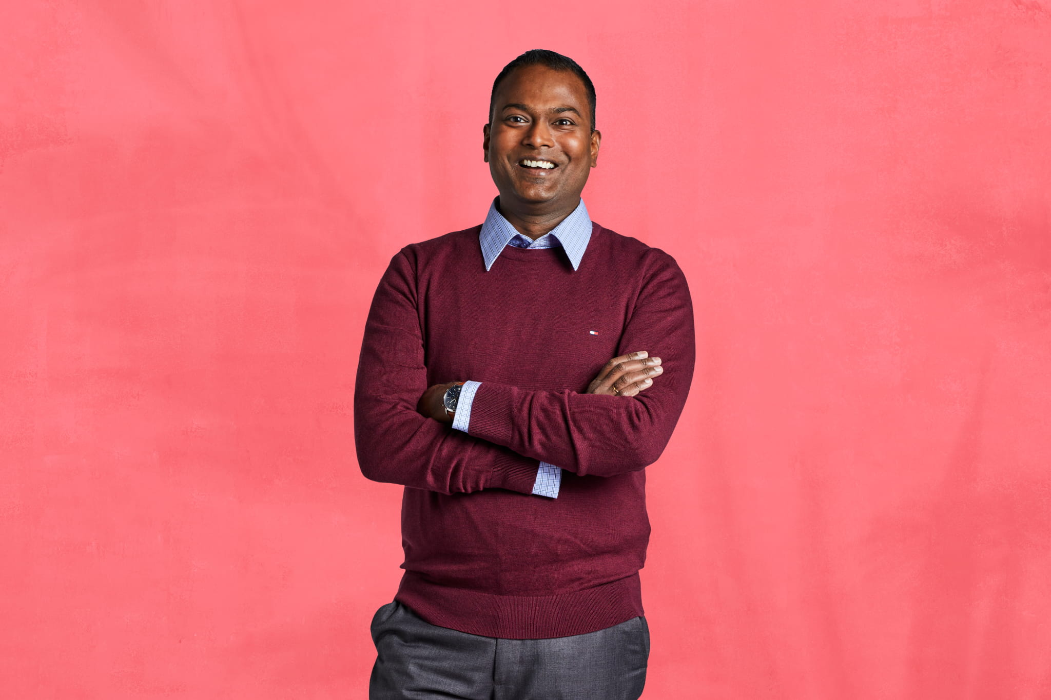 Man standing in front of coral background